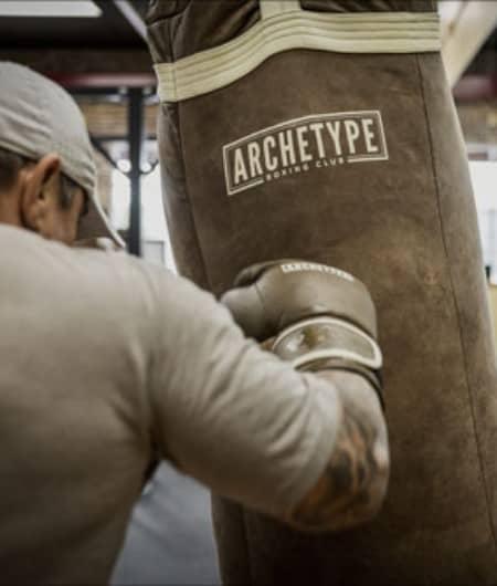 Man punching a hanging boxing bag
